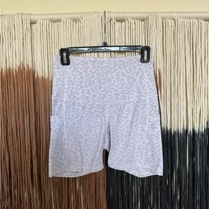 White and grey leopard print spandex bike shorts with pockets; good condition